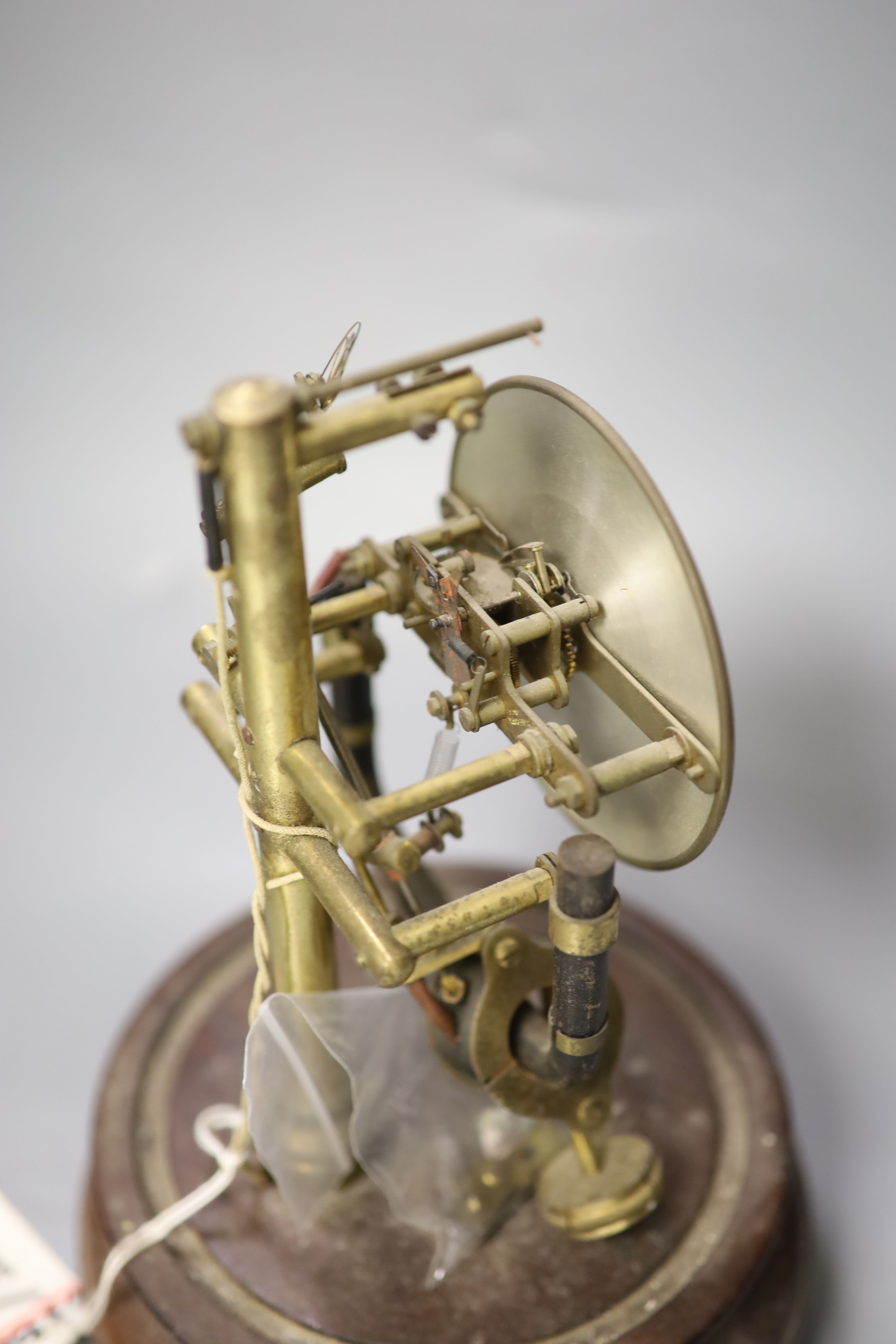 A Bulle electric mantel clock, under a glass dome, 25cm high